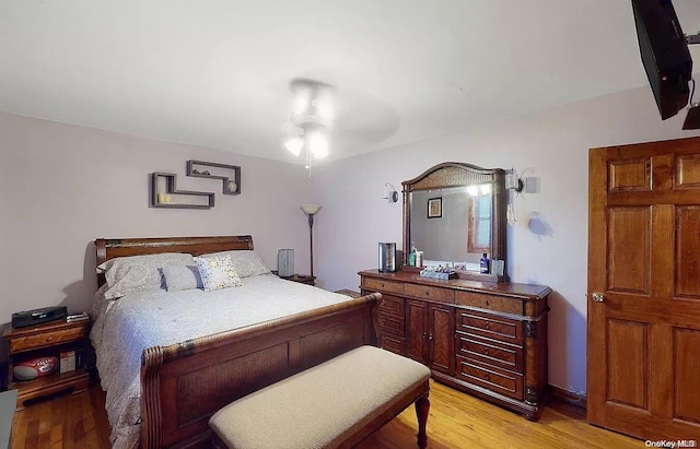 bedroom with ceiling fan and light hardwood / wood-style floors