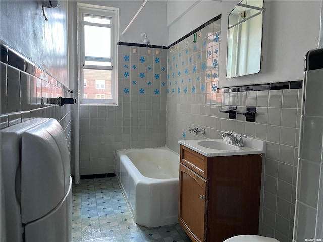 bathroom featuring vanity, shower / bath combination, and tile walls