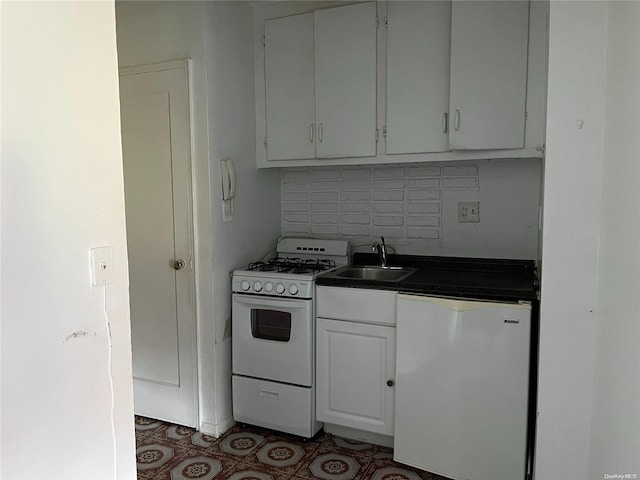 kitchen with white cabinetry, sink, tasteful backsplash, refrigerator, and white range with gas cooktop