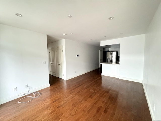 unfurnished living room with dark hardwood / wood-style flooring