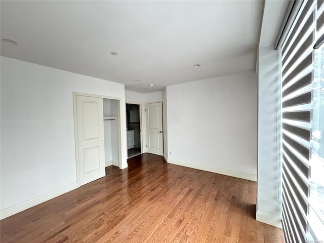 unfurnished bedroom featuring a closet and wood-type flooring