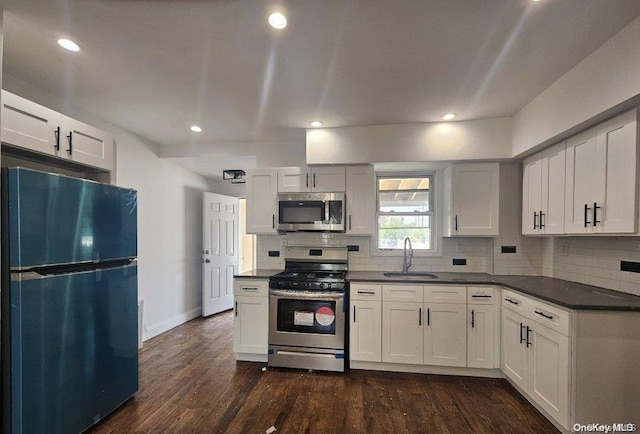 kitchen featuring white cabinets, dark hardwood / wood-style flooring, sink, and stainless steel appliances