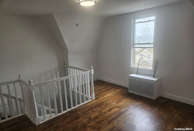 bonus room with vaulted ceiling and dark hardwood / wood-style floors