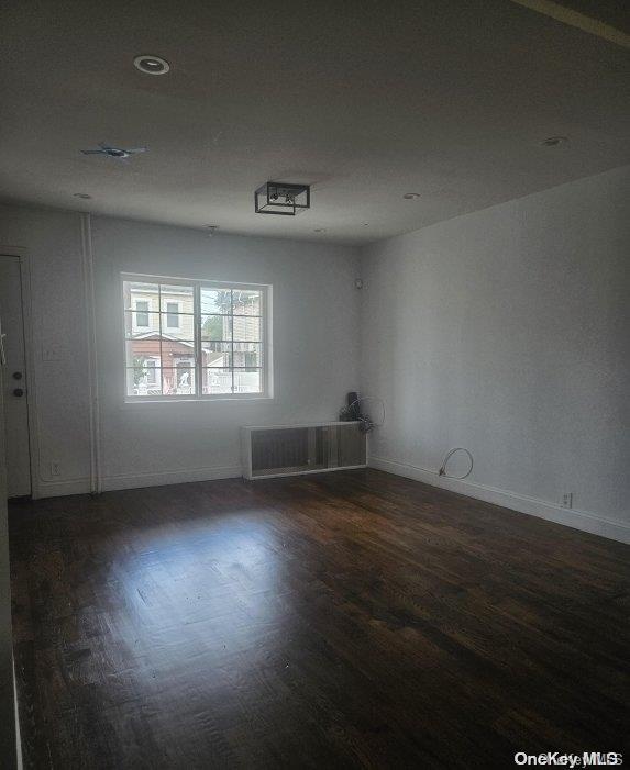 spare room with dark hardwood / wood-style floors