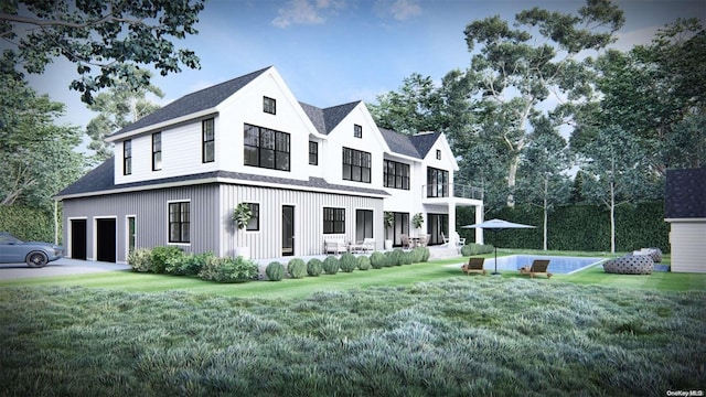 view of front of house featuring a front yard, a balcony, and a garage