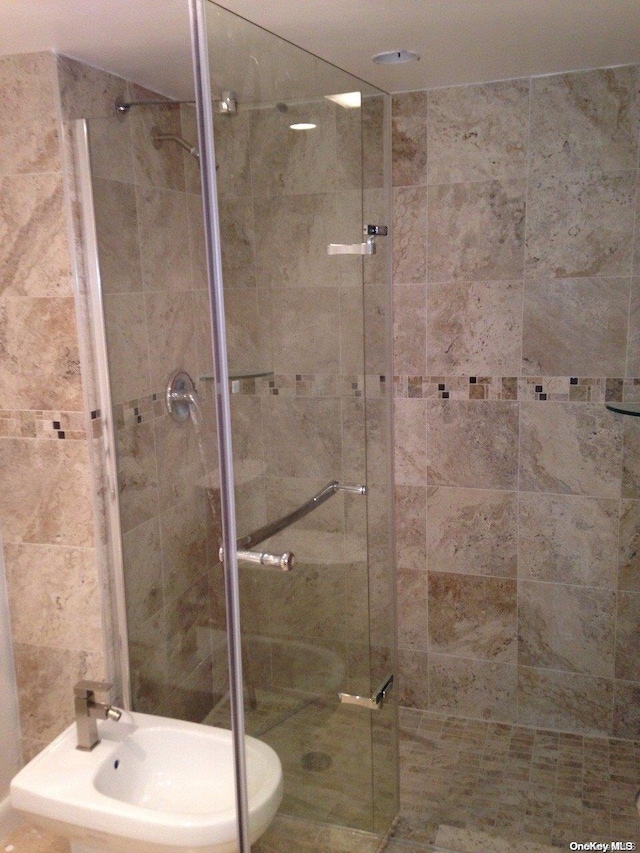 bathroom with walk in shower and a bidet