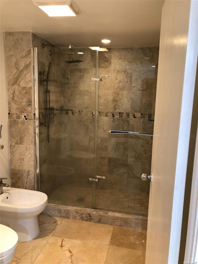 bathroom featuring an enclosed shower and a bidet