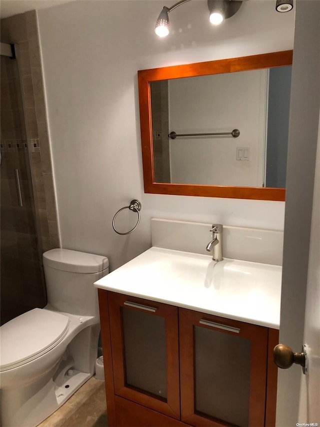 bathroom featuring vanity, toilet, and walk in shower