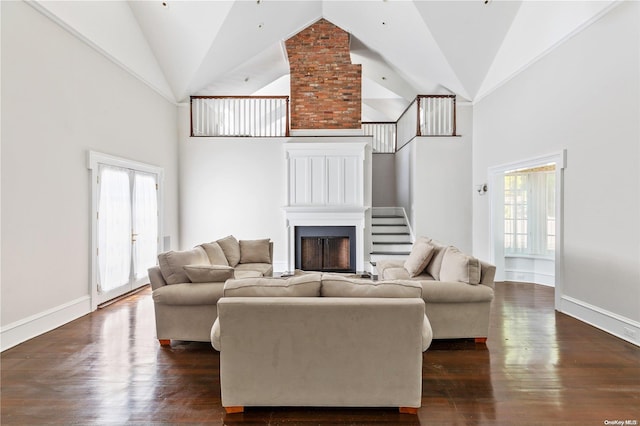 living room featuring dark hardwood / wood-style flooring and high vaulted ceiling