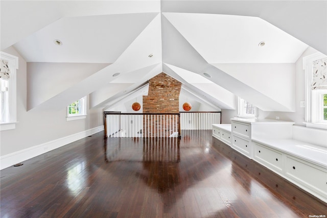 additional living space featuring dark hardwood / wood-style floors and vaulted ceiling