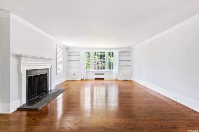 unfurnished living room with hardwood / wood-style floors, built in features, and crown molding