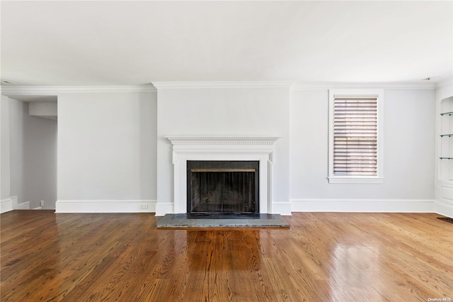 unfurnished living room with crown molding and hardwood / wood-style flooring