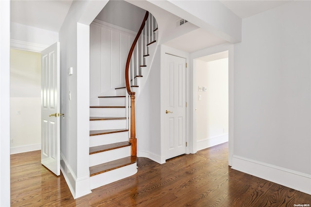 stairs featuring hardwood / wood-style flooring