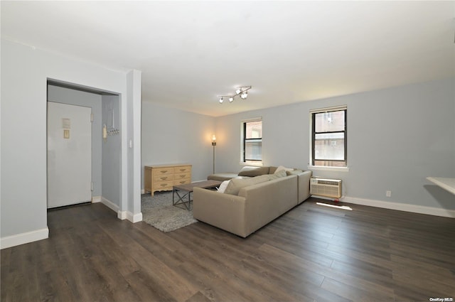 living room featuring an AC wall unit, dark wood finished floors, and baseboards