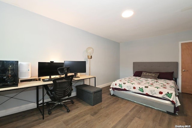 bedroom featuring dark wood finished floors and baseboards