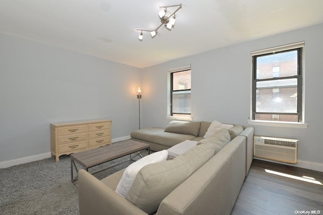 living room with dark hardwood / wood-style floors and an AC wall unit