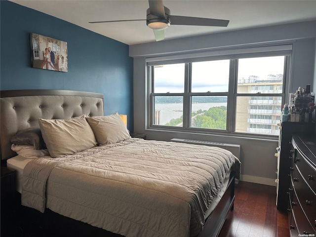 bedroom with dark hardwood / wood-style floors and ceiling fan