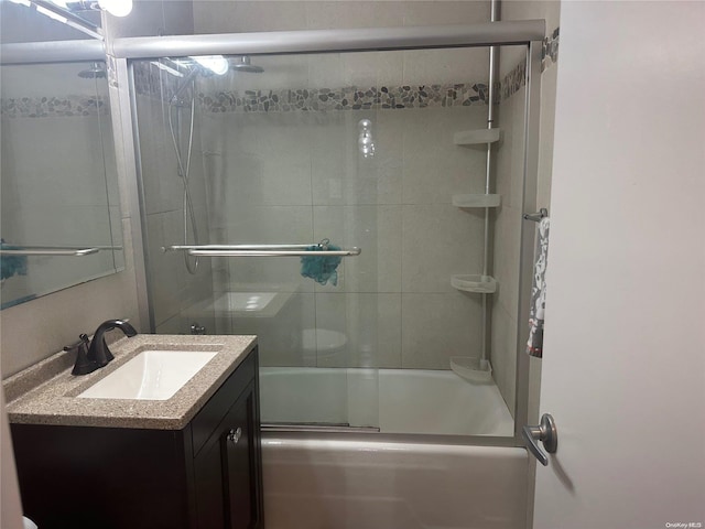 bathroom featuring vanity and enclosed tub / shower combo