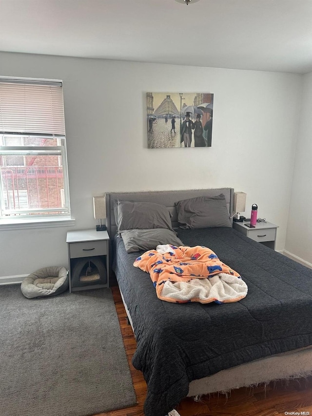 bedroom with dark wood-type flooring