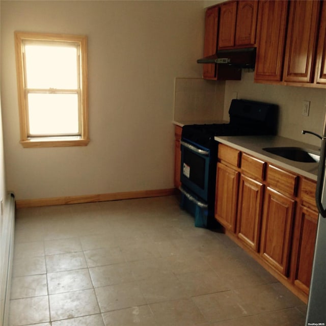 kitchen with electric range, a baseboard radiator, and sink