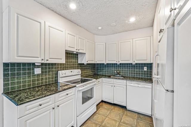 kitchen featuring a textured ceiling, tasteful backsplash, white cabinets, and white appliances