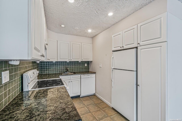 kitchen with white appliances, white cabinets, sink, a textured ceiling, and light tile patterned flooring