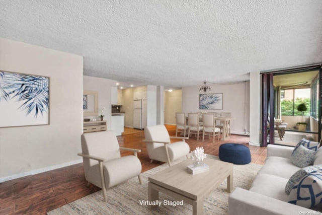 living room with light wood-type flooring and a textured ceiling