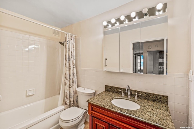 full bathroom featuring shower / bath combination with curtain, toilet, tile walls, and vanity