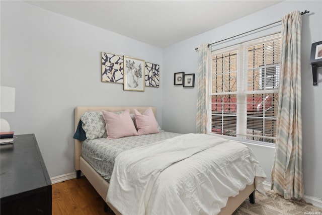 bedroom with dark hardwood / wood-style flooring