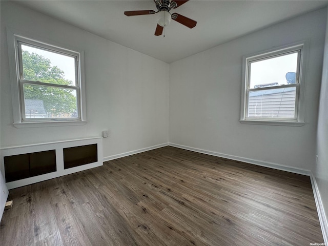 unfurnished room featuring ceiling fan and dark wood-type flooring