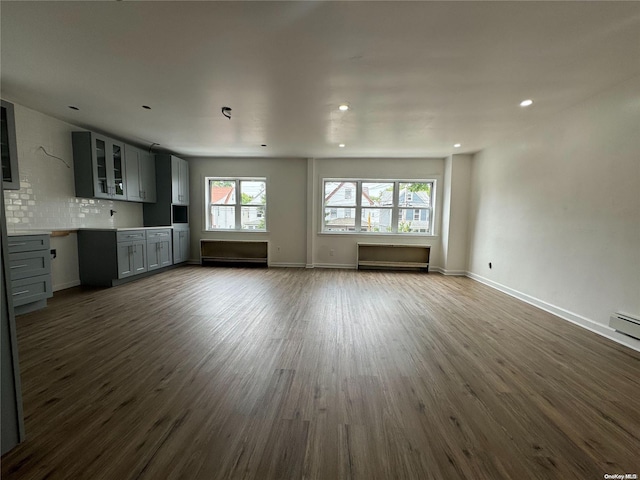 unfurnished living room featuring dark wood-type flooring