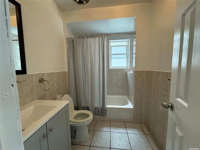 full bathroom with vanity, shower / bath combo with shower curtain, tile walls, tile patterned flooring, and toilet