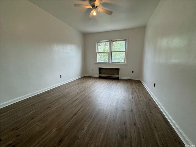 empty room with dark hardwood / wood-style floors and ceiling fan