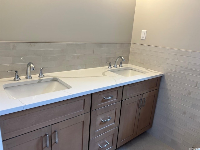 bathroom with vanity and tile walls