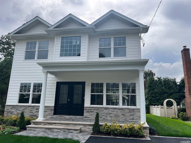 view of front facade featuring a porch and french doors