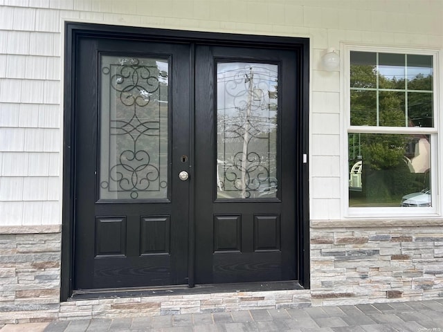 doorway to property with stone siding