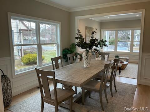 dining area with crown molding and hardwood / wood-style flooring