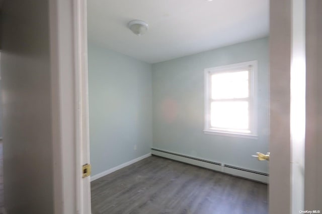 spare room with hardwood / wood-style floors and baseboard heating