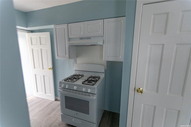 kitchen with white cabinets, white gas range oven, and light hardwood / wood-style flooring