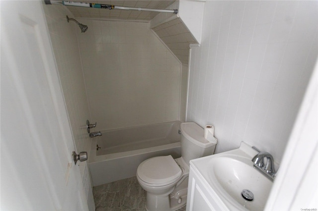 full bathroom featuring tile patterned floors, vanity, toilet, and tiled shower / bath combo