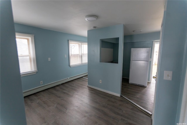 interior space with dark hardwood / wood-style flooring, plenty of natural light, and a baseboard radiator