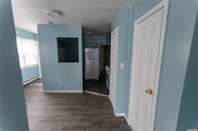 hallway with dark hardwood / wood-style floors and a baseboard heating unit