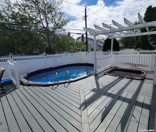 view of pool with a pergola and a deck