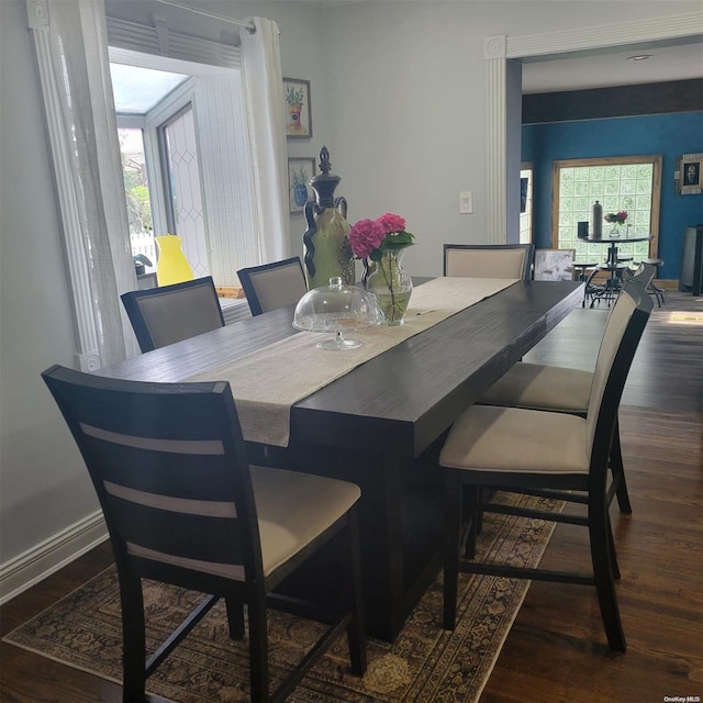 dining space featuring dark hardwood / wood-style flooring and a healthy amount of sunlight