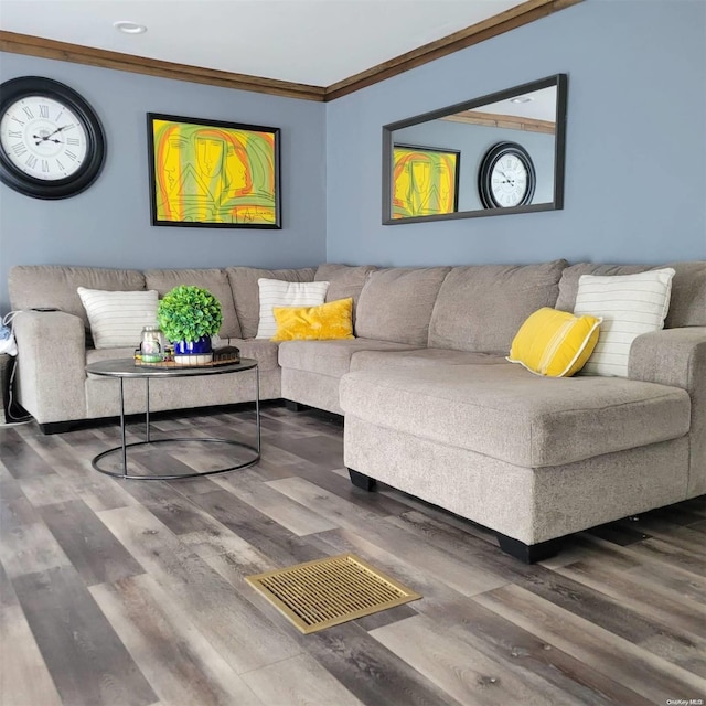 living room featuring crown molding and hardwood / wood-style flooring