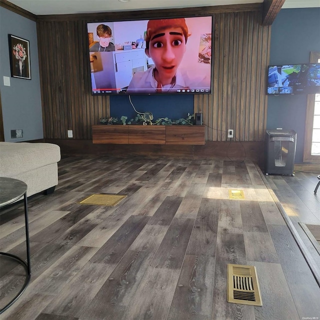 living room featuring hardwood / wood-style floors and crown molding