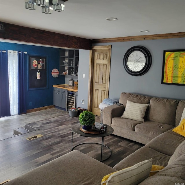 living room featuring bar area, wood-type flooring, and wine cooler