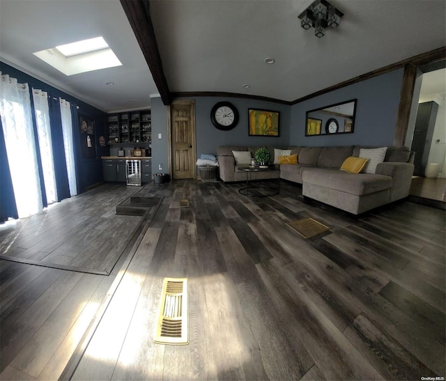 living room with dark hardwood / wood-style flooring, a skylight, ornamental molding, beverage cooler, and beamed ceiling