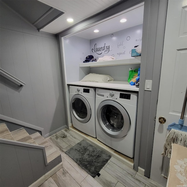 laundry room with light wood-type flooring and separate washer and dryer