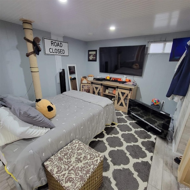 bedroom with hardwood / wood-style flooring